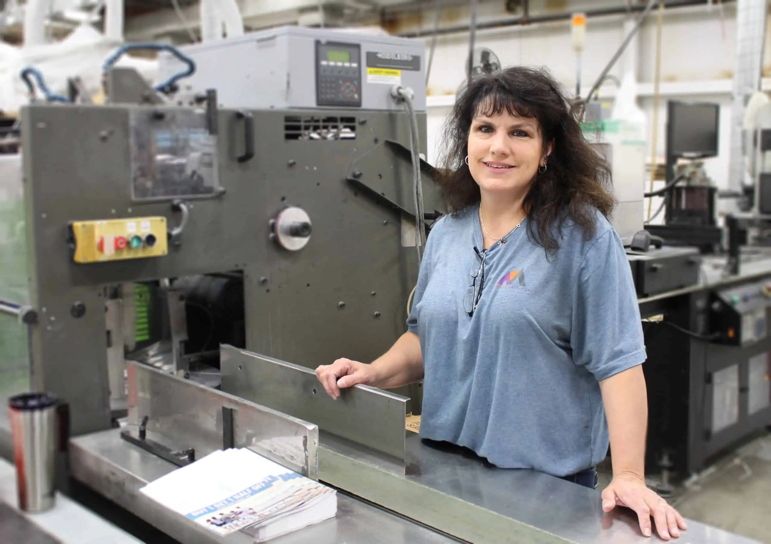 person working at bindery machine