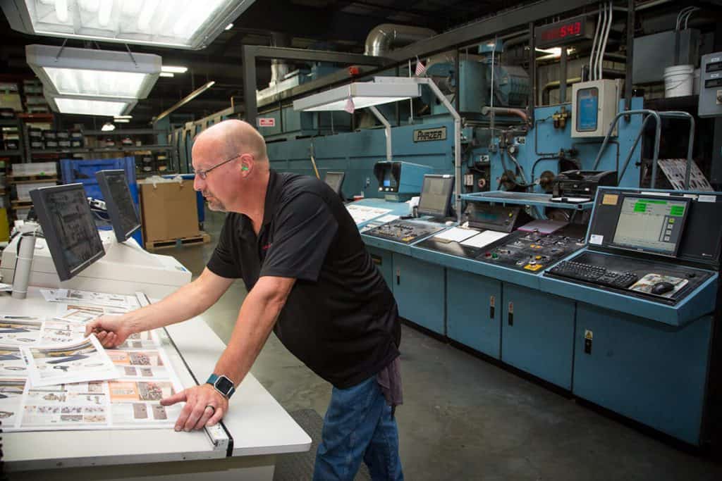 Person checking over printed materials