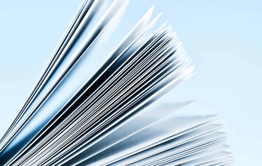 Close-up of magazine pages on light blue background
